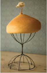 Mother's hat on a wire hat-stand.