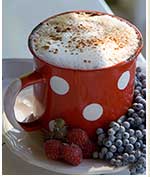 frothed coffee in polka-dot cup