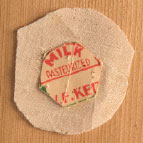 Cardboard hexagonal template on fabric piece