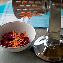 Hand shredder shredding carrots and beets