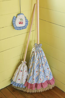 Brooms with aprons, waiting dutifully in the corner for their next task