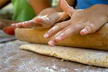 Hands rolling out the BakeOver crust